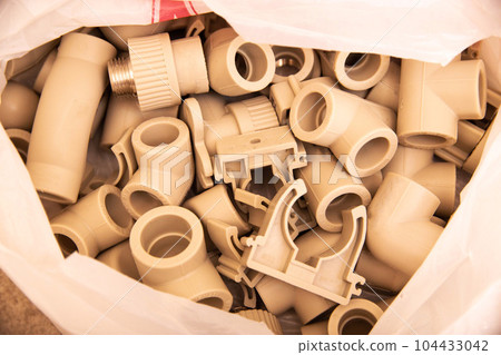 water fittings for plastic pipes in plumbing, close-up water fittings for plastic pipes in plumbing, close-up 104433042