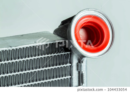 Part of a car heater radiator on a white background, close-up. Automotive spare part. Close-up Part of a car heater radiator on a white background, close-up. Automotive spare part. Close-up 104433054