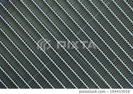 Texture of a honeycomb of an automotive aluminum car cooling radiator, close-up. 104433056