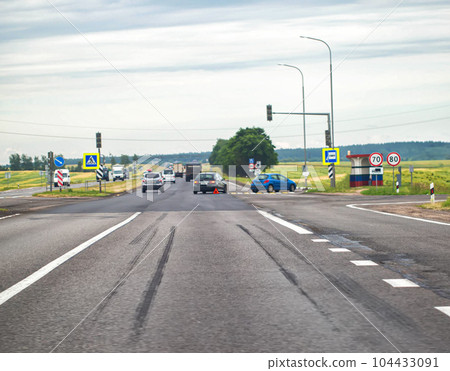 A traffic accident on a country road due to non-compliance with the speed limit. Braking path on asphalt. Blurry, copy space for text, industry 104433091