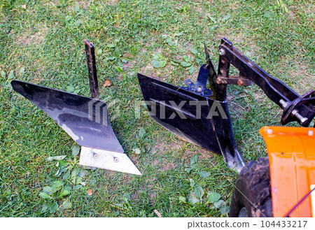 Plow and hiller complete with a walk-behind tractor for agricultural work. 104433217