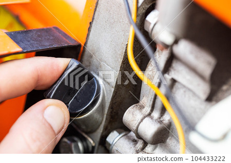 holes for pouring gear oil into the walk-behind tractor. Maintenance of equipment, industry. Close-up 104433222