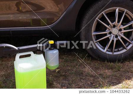 High pressure washer with foam nozzle for cleaning the car with foam. Modern concentrated shampoo. Foam generator High pressure washer with foam nozzle for cleaning the car with foam. Modern concentrated shampoo. Foam generator 104433262