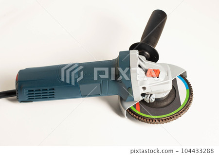 Modern professional angle grinder with a flap wheel on a white background. Power tool for work. Sanding wood and metal. 104433288