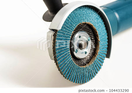 Modern professional angle grinder with a flap wheel on a white background. Power tool for work. Sanding wood and metal. 104433290