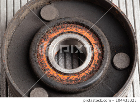Old bypass car roller. Roller jamming, close-up Old bypass car roller. Roller jamming, close-up 104433325