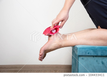Heel spur treatment with hot water bottle. Heat therapy. Copy space for text Heel spur treatment with hot water bottle. Heat therapy. Copy space for text 104433411