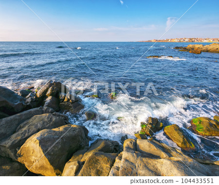 rocks on the seaside of resort town. vacation and leisure background in summertime rocks on the seaside of resort town. vacation and leisure background in summertime 104433551