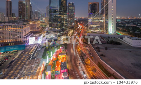 Dubai International Financial district aerial day to night timelapse. Panoramic view of business and financial office towers. Dubai International Financial district aerial day to night timelapse. Panoramic view of business and financial office towers. 104433976