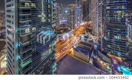 Panoramic view of the Dubai Marina and JBR area and the famous Ferris Wheel aerial night timelapse Panoramic view of the Dubai Marina and JBR area and the famous Ferris Wheel aerial night timelapse 104433992