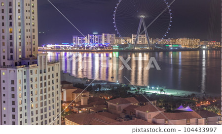 Bluewaters island with modern architecture and ferris wheel aerial day to night timelapse. 104433997