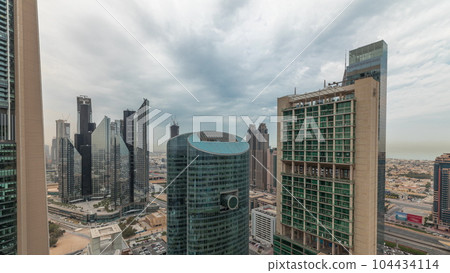Panorama showing Dubai international financial center skyscrapers with promenade on a gate avenue aerial timelapse. 104434114