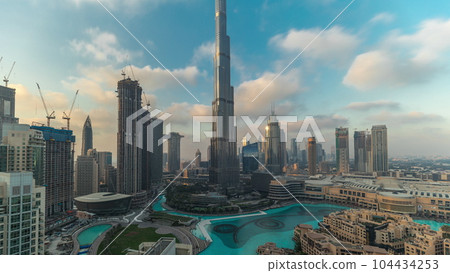 Skyscrapers rising above Dubai downtown timelapse, mall and fountain surrounded by modern buildings aerial top view Skyscrapers rising above Dubai downtown timelapse, mall and fountain surrounded by modern buildings aerial top view 104434253