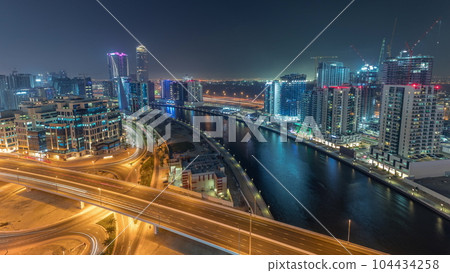 Skyscrapers at the Business Bay aerial day to night timelapse in Dubai, United Arab Emirates 104434258