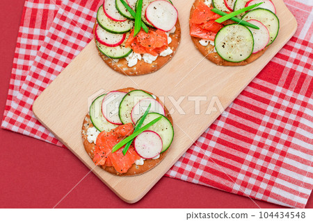 Cracker Sandwiches with Salmon, Cucumber, Radish, Cottage Cheese and Green Onions Cracker Sandwiches with Salmon, Cucumber, Radish, Cottage Cheese and Green Onions 104434548