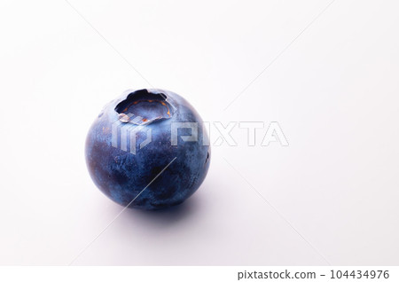 Blueberries on a white background. One juicy fresh blueberry lies sideways 104434976