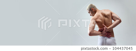 Cropped image of beautiful, strong, muscular, relief male's back against grey studio background Cropped image of beautiful, strong, muscular, relief male's back against grey studio background 104437045