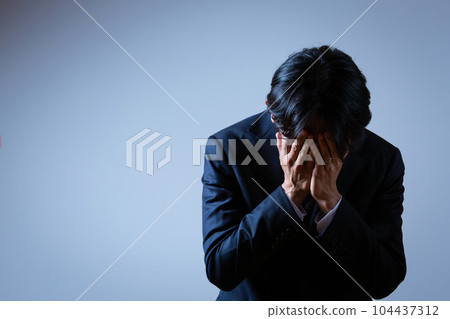 Men covering face Men covering face 104437312