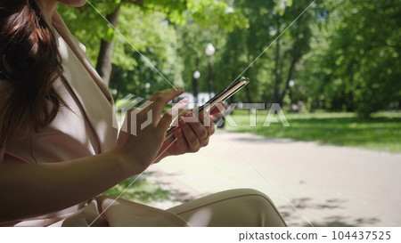 phone and woman in park for typing social phone and woman in park for typing social 104437525
