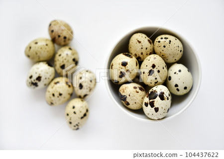 Quail eggs in a white plate. Food eggs on a white background. Quail eggs in a white plate. Food eggs on a white background. 104437622