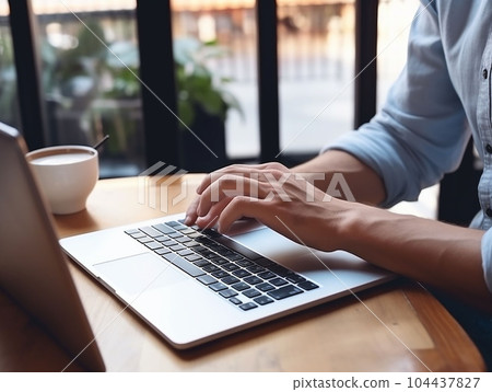 hands of a man working on a computer 104437827