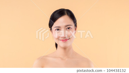 beauty asian young woman model with fresh glowing hydrated facial skin. girl person with natural makeup and healthy skin portrait isolated on beige studio background. spa treatment, skin care concept. beauty asian young woman model with fresh glowing hydrated facial skin. girl person with natural makeup and healthy skin portrait isolated on beige studio background. spa treatment, skin care concept. 104438132