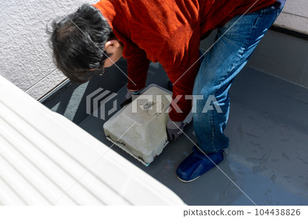 A man cleaning the balcony Balcony A man cleaning the balcony Balcony 104438826