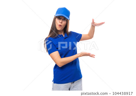 active young brunette woman promoter in blue t-shirt and cap gesturing with hands 104438917
