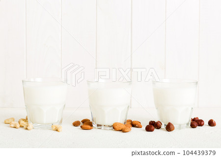 Set or collection of various vegan milk almond, cashew, on table background. Vegan plant based milk and ingredients, top view Set or collection of various vegan milk almond, cashew, on table background. Vegan plant based milk and ingredients, top view 104439379