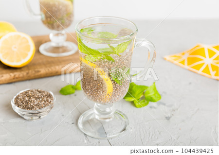 Healthy breakfast or morning with chia seeds lemon and mint on table background, vegetarian food, diet and health concept. Chia pudding with lemon and mint Healthy breakfast or morning with chia seeds lemon and mint on table background, vegetarian food, diet and health concept. Chia pudding with lemon and mint 104439425