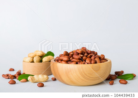 Fresh healthy peanuts in bowl on colored table background. Top view Healthy eating bertholletia concept. Super foods 104439433