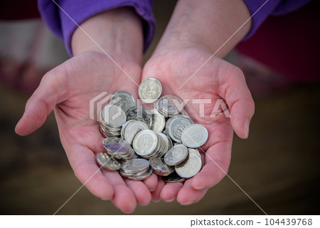 Many Ukrainian kopecks in hand. UAH. Currency of Ukraine. Keep the money 104439768