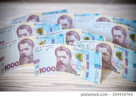 Close up 1000 Ukrainian money hryvnia on white background. Business flat lay with copy space for text. Crisis and problem of financial turbulence, inflation, devalvation, economics depression 104439769