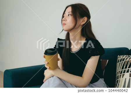 A woman relaxing on the sofa 104440042