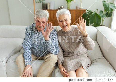 Happy senior woman man talk on video call with friends family. Mature old grandmother grandfather talking speaking with grown up children online. Older generation modern tech usage. Webcamera view Happy senior woman man talk on video call with friends family. Mature old grandmother grandfather talking speaking with grown up children online. Older generation modern tech usage. Webcamera view 104440137