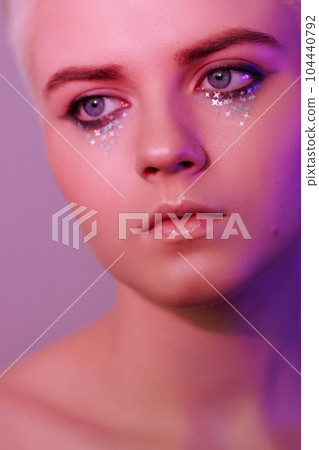 Portrait of a beautiful young woman with short hair in neon light 104440792