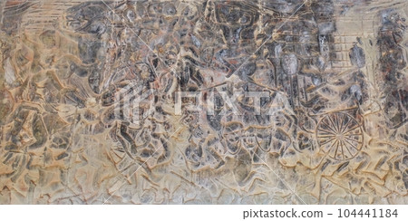 A captivating display of ancient art, featuring detailed carvings of Hindu mythology's battle scenes on the walls of a historic Khmer temple. A captivating display of ancient art, featuring detailed carvings of Hindu mythology's battle scenes on the walls of a historic Khmer temple. 104441184