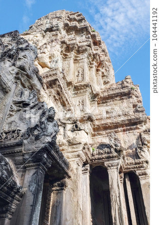 A mesmerizing view of the carved stone walls depicting historical narratives at the ancient Angkor Temple, Cambodia. A mesmerizing view of the carved stone walls depicting historical narratives at the ancient Angkor Temple, Cambodia. 104441192