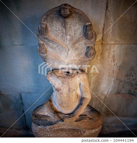 A headless Buddha statue in the lotus pose captured inside a Cambodian temple. 104441194