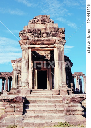 A solitary ancient stone structure in the renowned, abandoned Khmer city of Angkor under the sun. A solitary ancient stone structure in the renowned, abandoned Khmer city of Angkor under the sun. 104441206