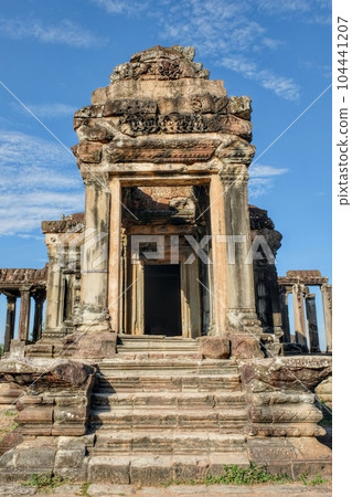 Photograph of an ancient stone structure in the famous deserted city of Angkor, Khmer, on a bright day. Photograph of an ancient stone structure in the famous deserted city of Angkor, Khmer, on a bright day. 104441207