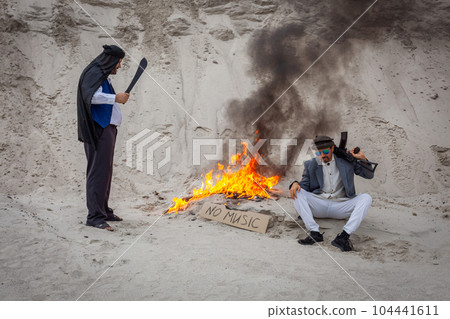 Afghan terrorists destroy music with fire. 104441611