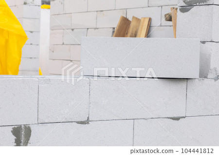 Gas block lies on the wall at the construction site. 104441812