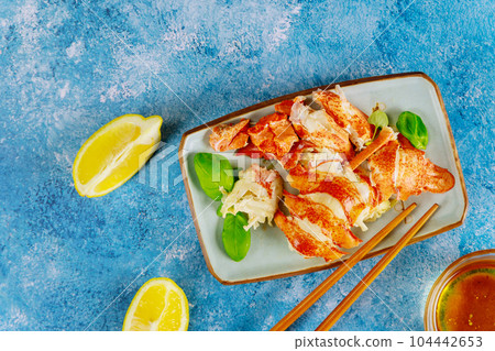 Fresh lobster is cooked to perfection in our gourmet dinner kitchen served with lemon. Fresh lobster is cooked to perfection in our gourmet dinner kitchen served with lemon. 104442653