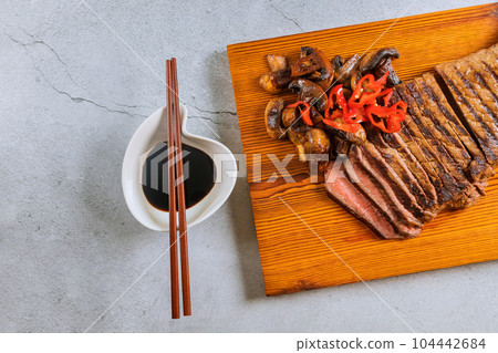 It is juicy tender medium rare beef steak that is sliced thinly. 104442684