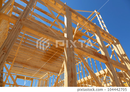 The wooden beams sticks that being used to build a new house are being installed 104442705