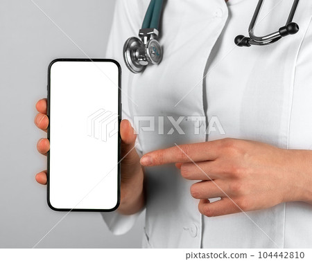 Mobile phone mockup in doctor hands closeup Mobile phone mockup in doctor hands closeup 104442810
