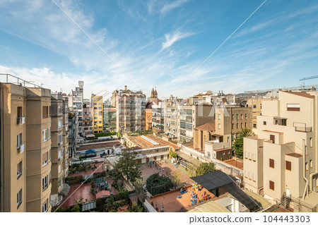 Cityscape of residential district in barcelona with impressive architecture against a clear sky 104443303