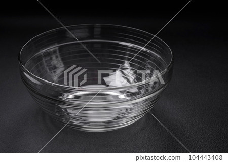 Transparent glass bowl as an element of kitchen utensils for cooking at home 104443408