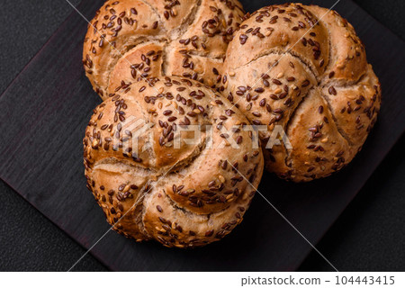 Delicious freshly baked crispy bun or kaiser roll with sesame seeds 104443415